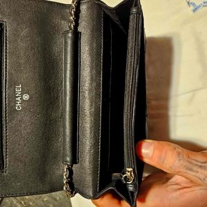 An 2005 Chanel clutch wallet with a real silver chain. It's a real Chanel purse